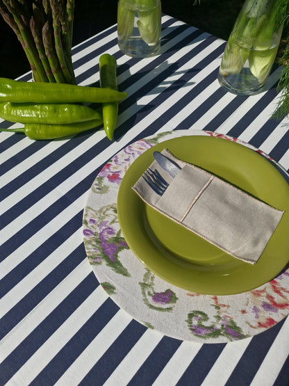 Mantel rectangular Rayas Marengo puesto en mesa al aire libre con vajilla verde