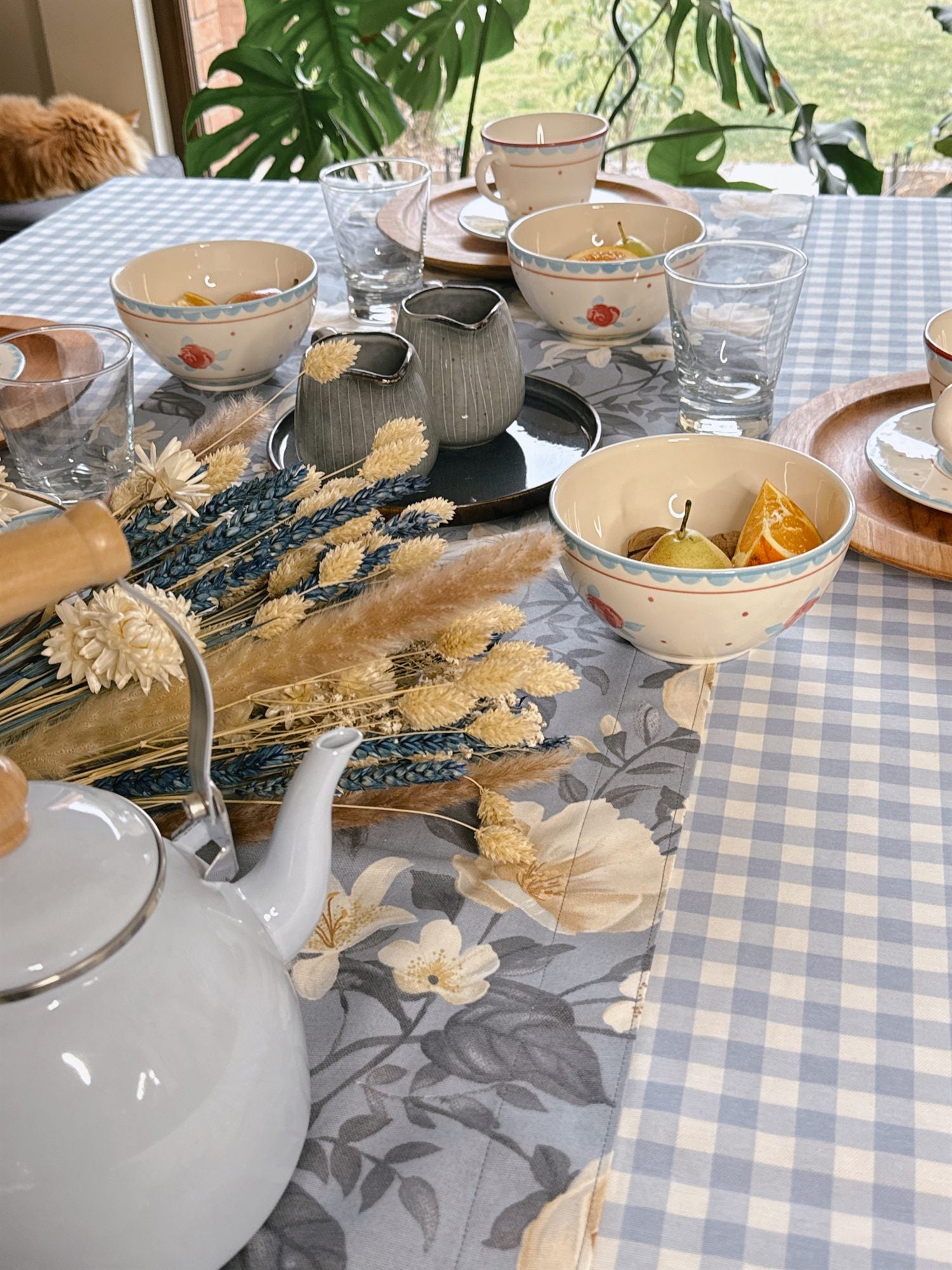 Mesa de té con mantel vichy celeste Tischdecke, teteras y flores secas